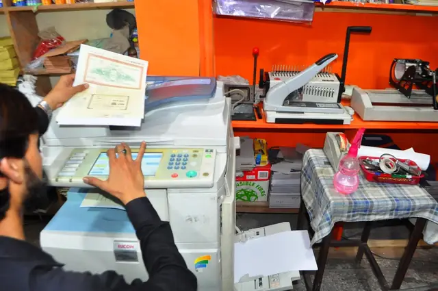 Photocopier with binding and laminating machines beside it